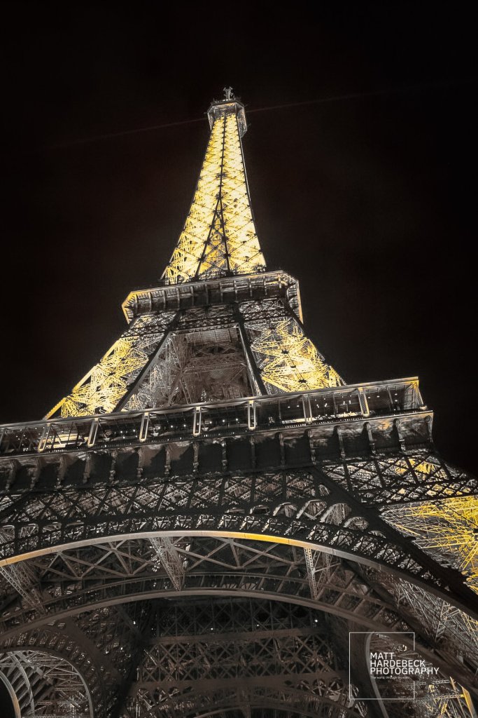 Night close-up upward angle of the Eiffel Tower