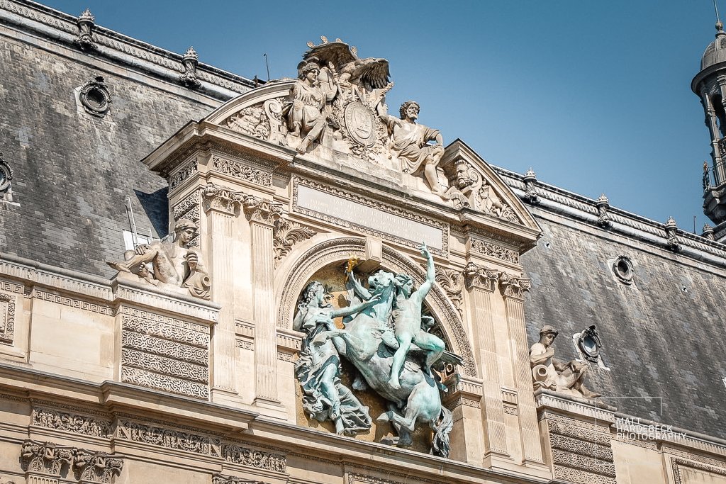 Ornate rooftop sculpture above the palace entrance.