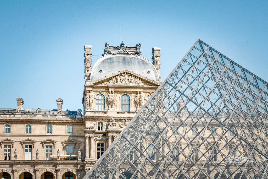 Glass pyramid against the backdrop of the palace’s stately elegance.
