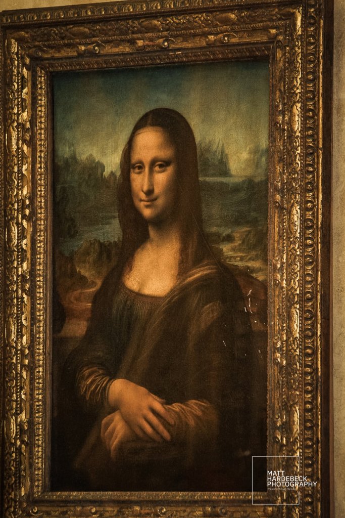 Smiling through centuries of mystery, the Mona Lisa reigns as the Louvre’s most iconic masterpiece.