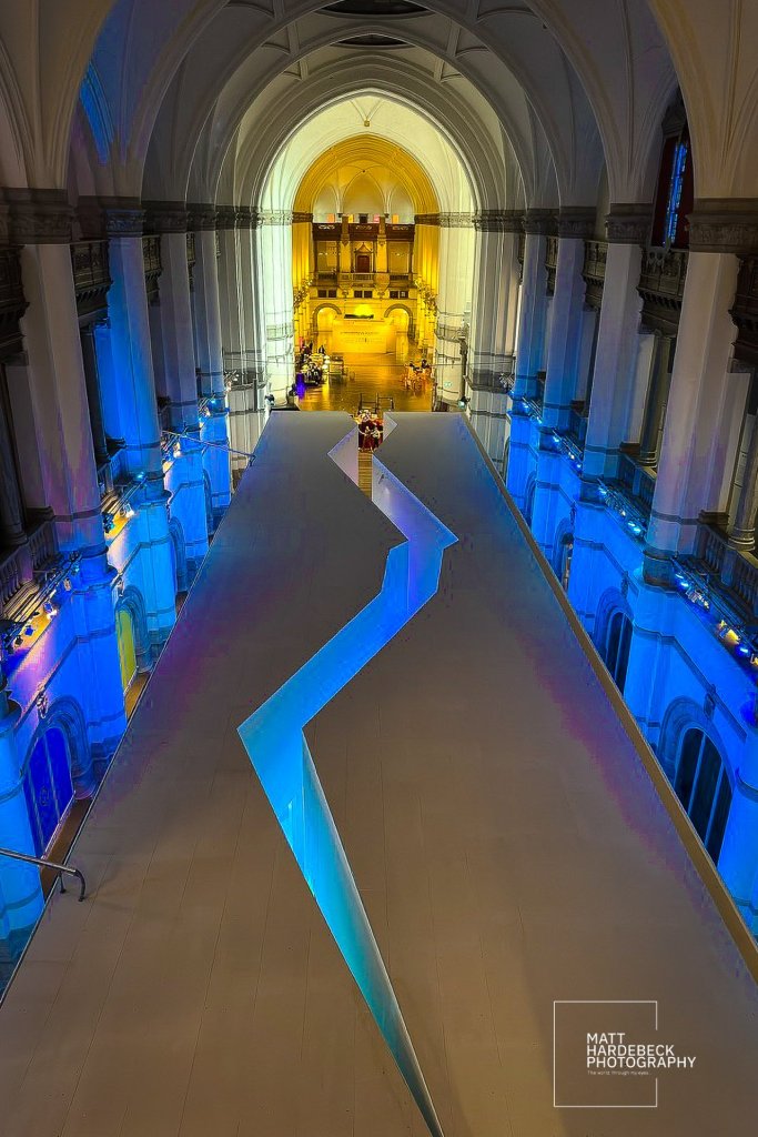 Exhibit hall bathed in blue and gold light, by the zigzag walkway of the glacier exhibit.