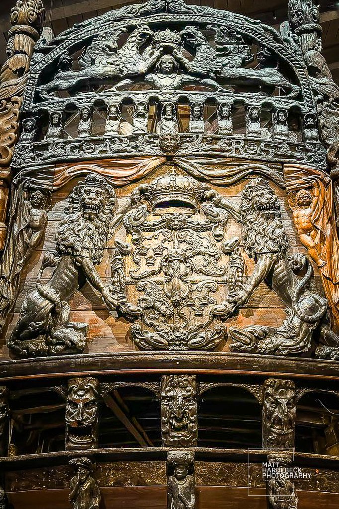 Close-up of elaborate carvings along Vasa’s hull, including carved lions and royal crest.