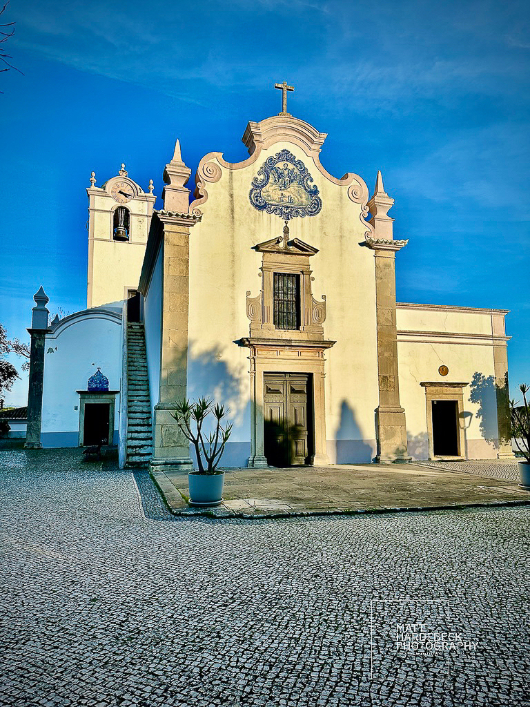 Baroque-style church with blue-and-white azulejo tilework in Almancil, Portugal.