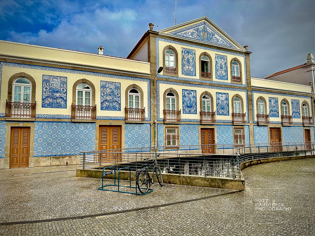Building in Aveiro, Portugal, decorated with intricate blue-and-white azulejo tile panels.
