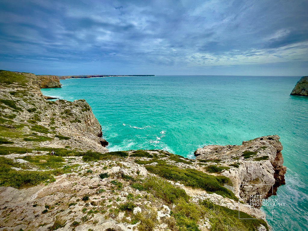 Dramatic coastal cliffs and turquoise waters at Cabo de São Vicente, Portugal.