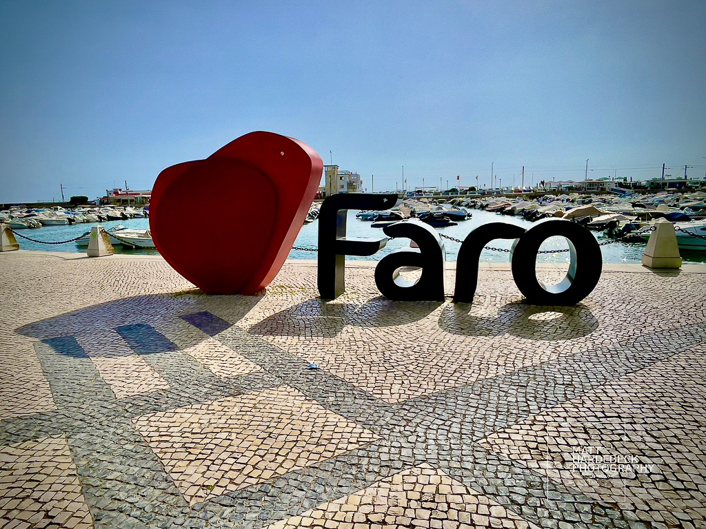 Large red heart sculpture with the word “Faro” by the marina.