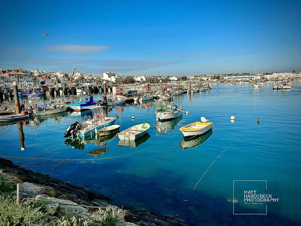 Fishing boats moored in calm blue waters at Lagos harbor.