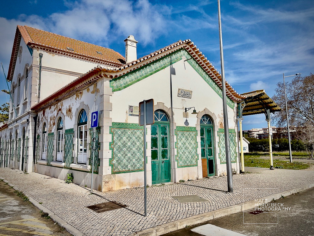 Old Lagos railway station building with green and white azulejo tilework on the façade.