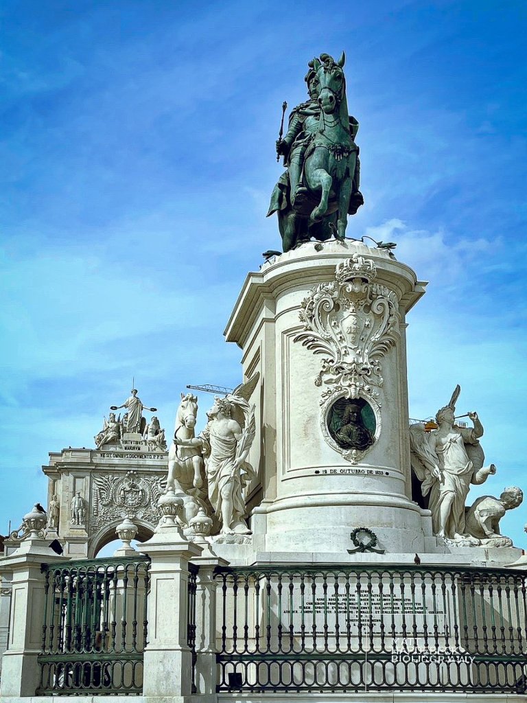 Bronze equestrian statue of King José I at Lisbon’s Praça do Comércio, surrounded by elaborate white stone sculptures.