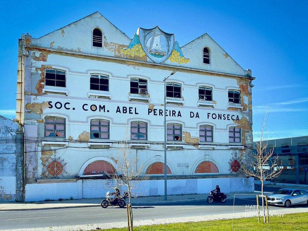Weathered facade of the Abel Pereira da Fonseca building, a historic wine warehouse in Lisbon.