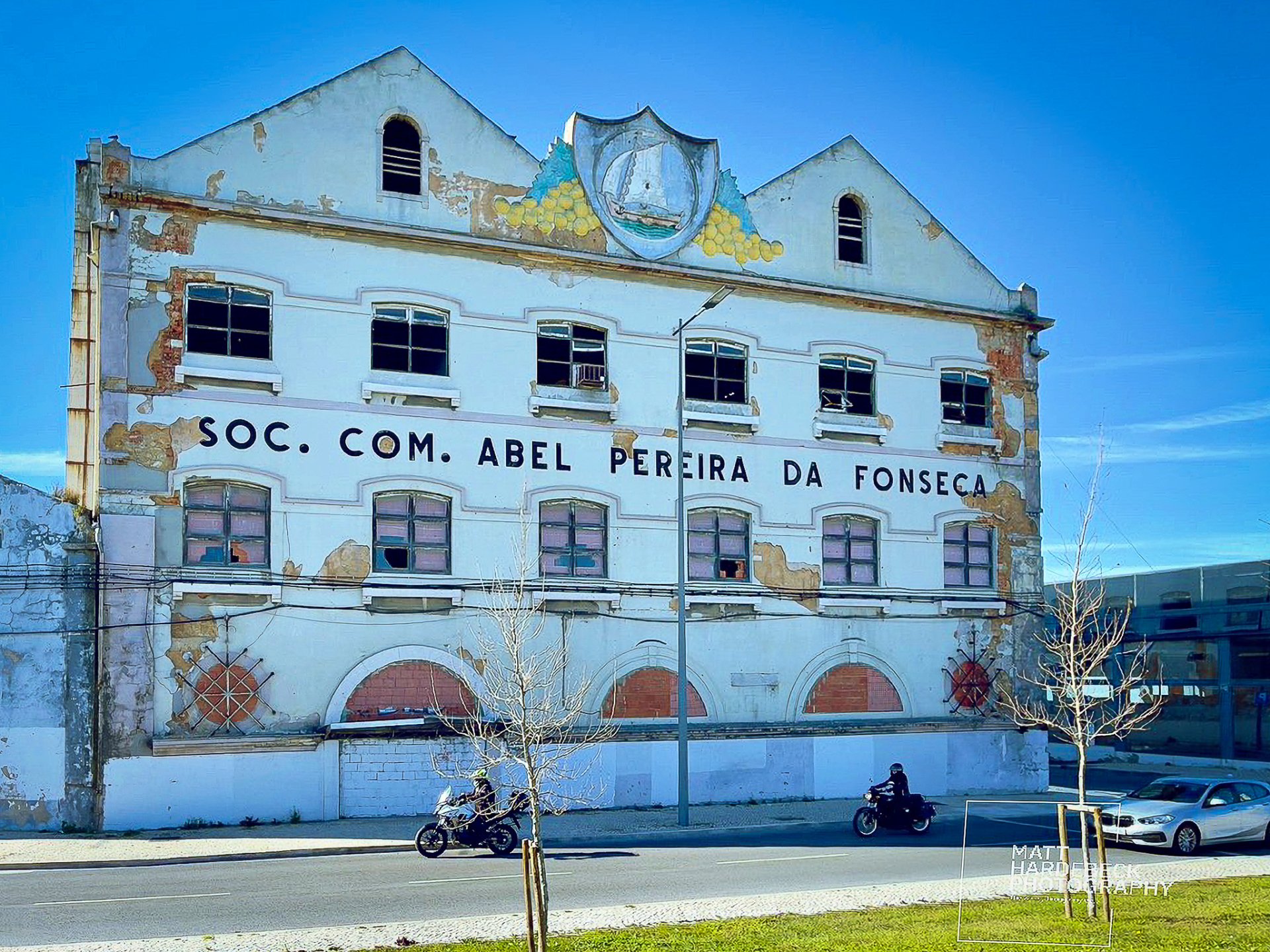 Weathered facade of the Abel Pereira da Fonseca building, a historic wine warehouse in Lisbon.