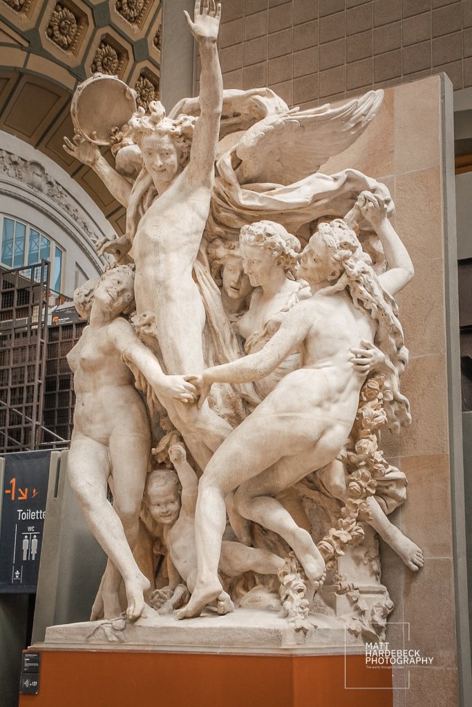 Plaster sculpture La Danse by Jean-Baptiste Carpeaux at the Musée d'Orsay, featuring lively nude figures in motion encircling a winged central figure.
