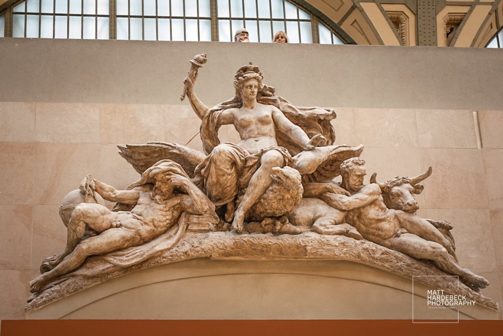 Plaster relief sculpture The Triumph of the Republic by Jules Dalou at the Musée d'Orsay, showing a commanding female figure flanked by allegorical male figures and a lion.