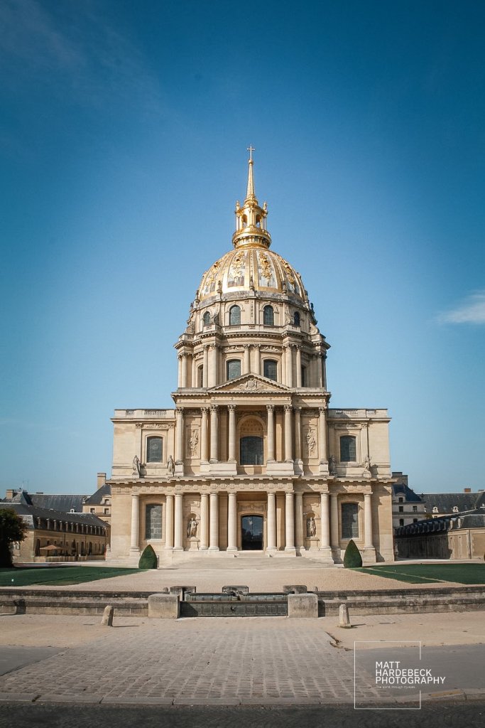 Front view of Les Invalides in Paris with golden dome against blue sky