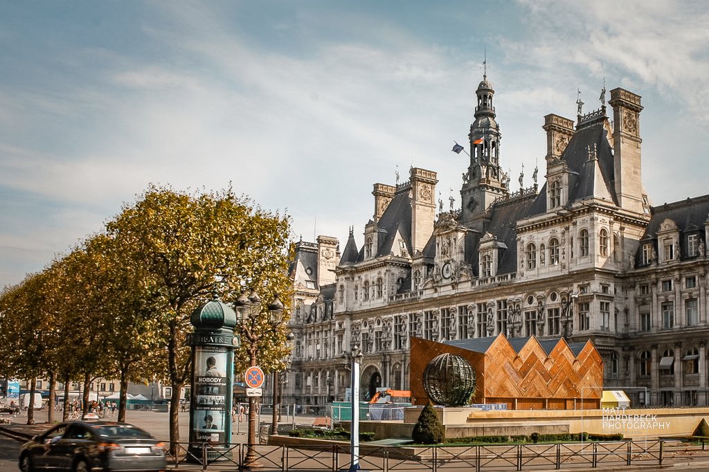 Hôtel de Ville (City Hall of Paris) with autumn trees and a temporary installation in the square.