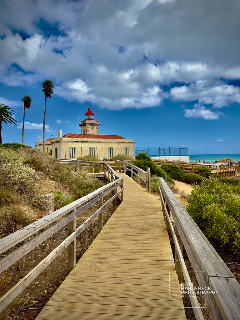 Lighthouse at Ponta da Piedade, reached by a wooden boardwalk.