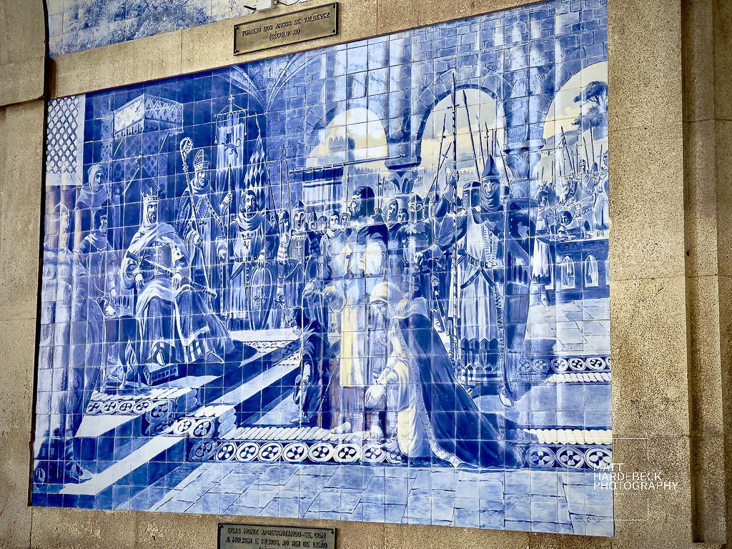 Blue-and-white azulejo mural in Porto, Portugal, depicting a historic royal court scene.