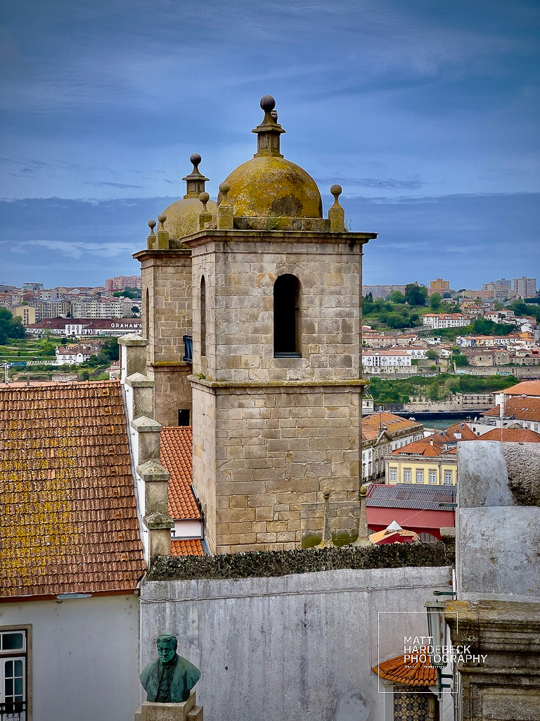 Twin-towered bell structure of Porto Cathedral with city views beyond.
