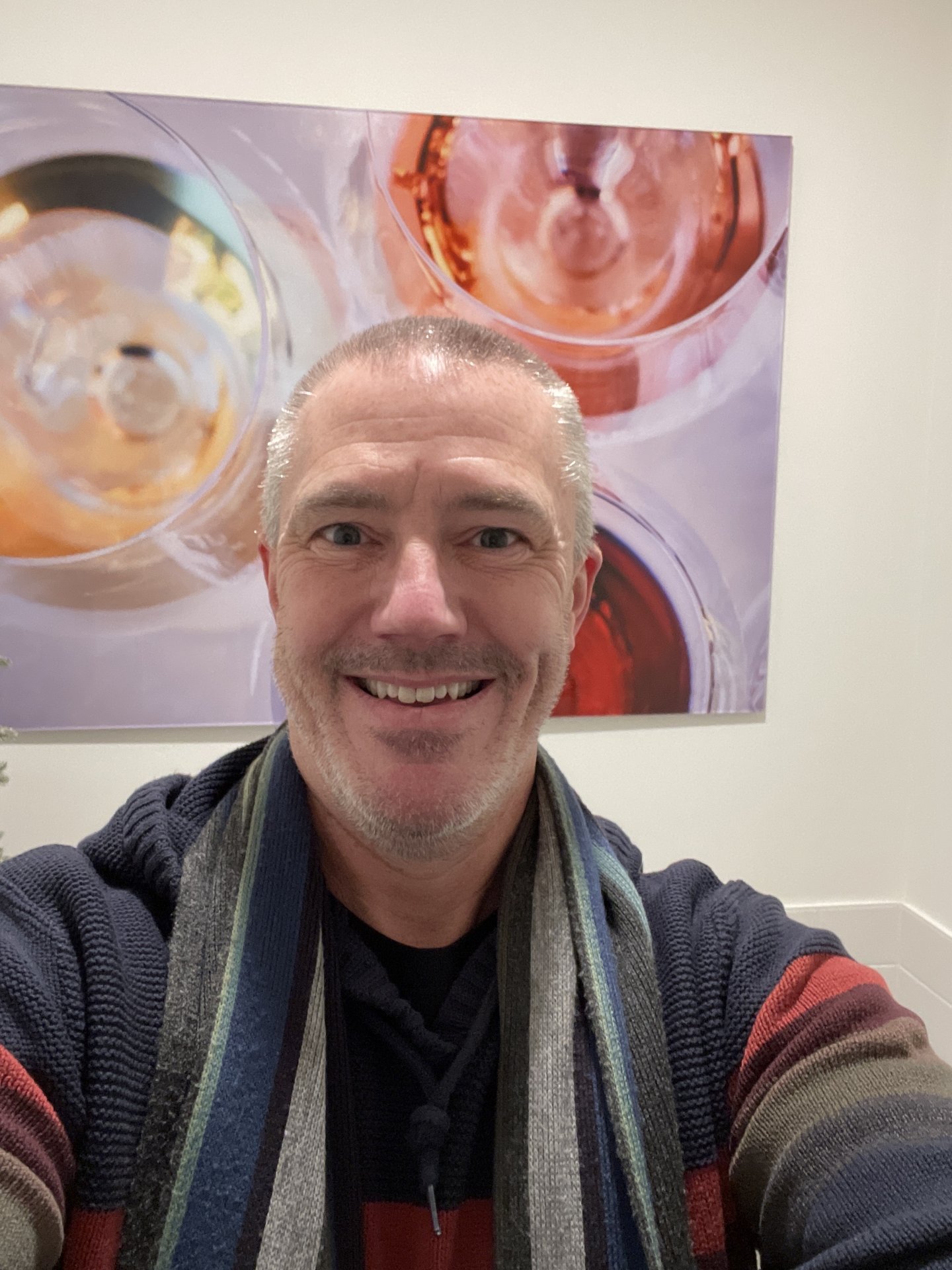 Smiling person in colorful sweater with abstract art background